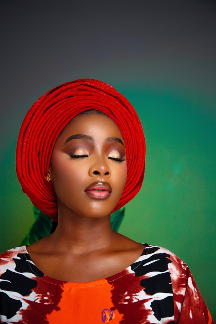 Eyes closed, green backdrop